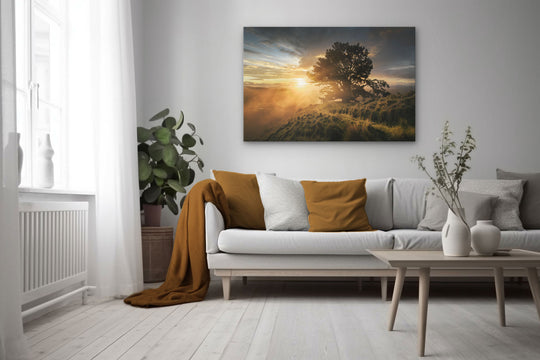 Canvas photo wall art of New Zealand landscape in neutral lounge setting with a white couch, cushions, coffee tables and plant