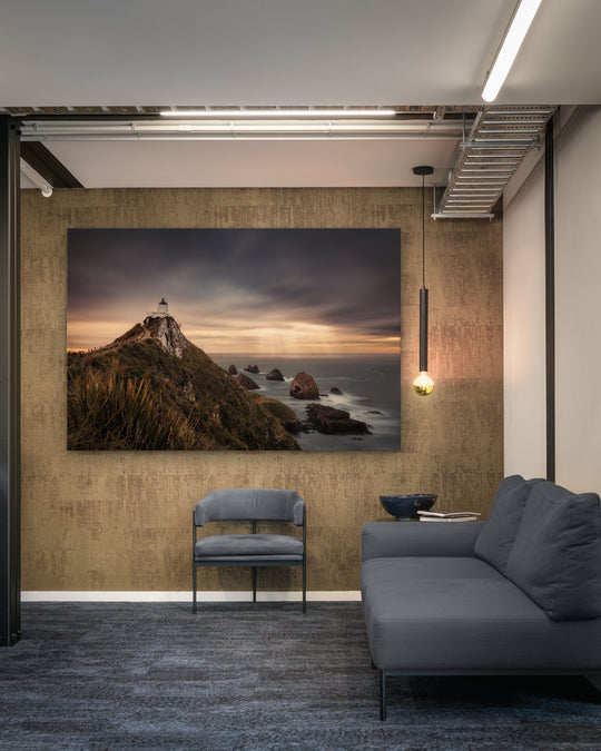 Canvas photo of New Zealand landscape on the wall of an industrial office with couch, chair and pendant light.