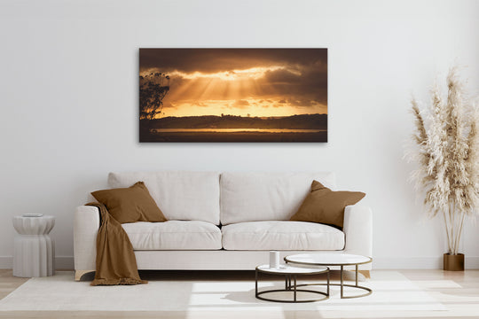 New Zealand landscape photo canvas wall art in neutral lounge setting with a white couch, cushions, coffee tables and plant
