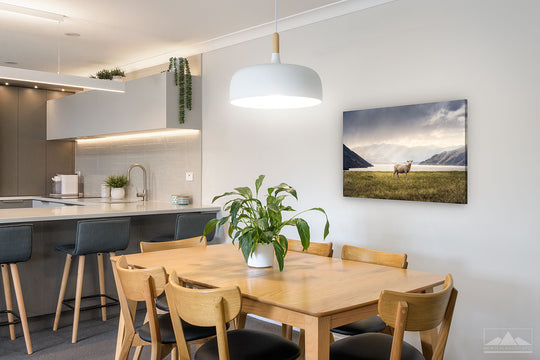 Photo canvas on dining room wall of New Zealand landscape photo of a sheep by a lake