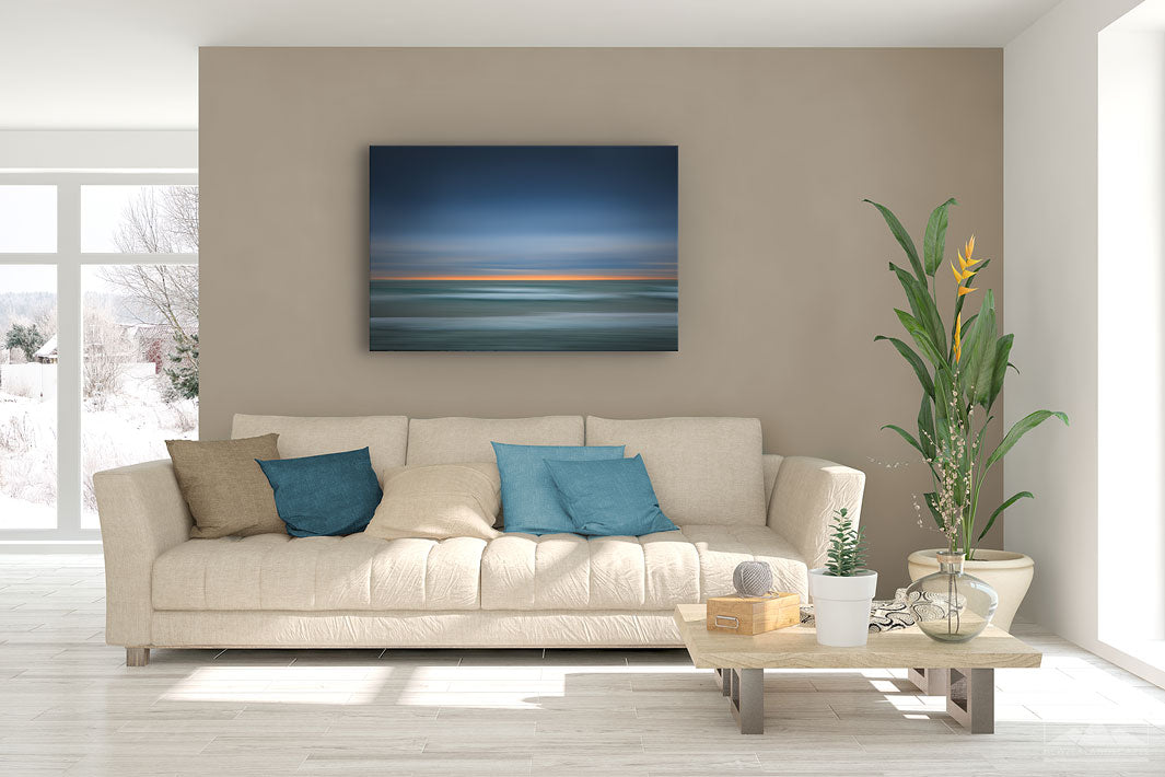 New Zealand landscape canvas photo wall art in lounge setting with a brown wall, white couch, coffee table, plant, cushions