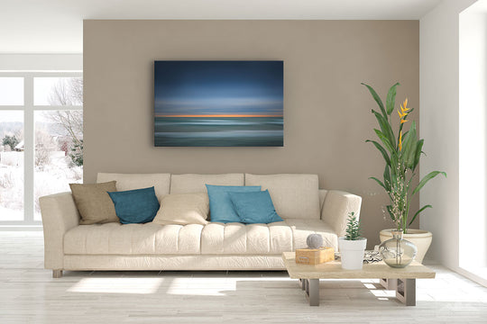 New Zealand landscape canvas photo wall art in lounge setting with a brown wall, white couch, coffee table, plant, cushions