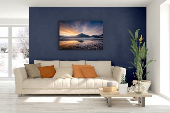 New Zealand landscape canvas photo wall art in lounge setting with a blue wall, white couch, coffee table, plant, cushions