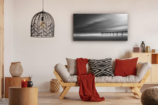 Canvas photo wall art of New Zealand landscape canvas print in lounge setting with a couch, cushions, coffee tables, and pendant light.