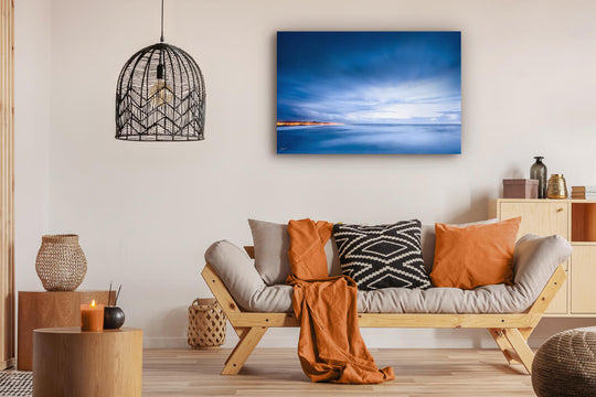 Canvas photo wall art of New Zealand landscape canvas print in lounge setting with a couch, cushions, coffee tables, and pendant light.
