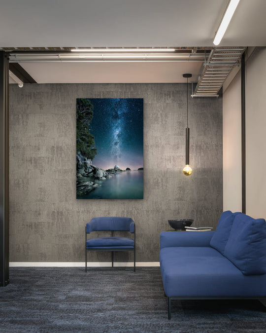 Canvas photo of New Zealand landscape on the wall of an industrial office with couch, chair and pendant light.