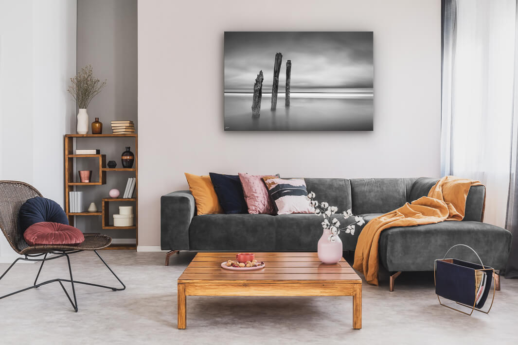 New Zealand landscape photo canvas wall art in neutral lounge setting with a grey couch, coffee tables and books
