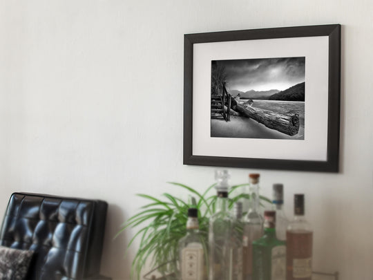 Framed photo print of the Abel Tasman National Park on office wall.
