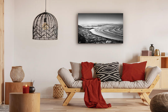 Canvas photo wall art of New Zealand landscape canvas print in lounge setting with a couch, cushions, coffee tables, and pendant light.