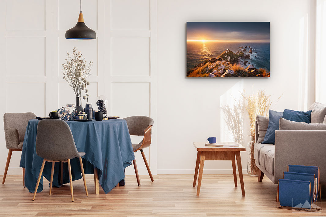 Canvas wall art photo on a dining room wall of the sunrise at Nugget Point lighthouse in Otago, New Zealand