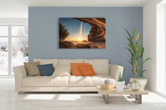 New Zealand landscape canvas photo wall art in lounge setting with a pale blue wall, white couch, coffee table, plant, cushions