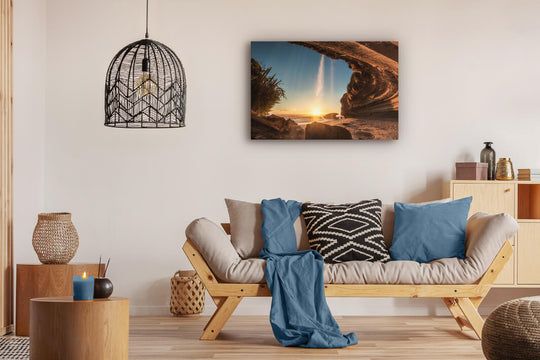 Canvas photo wall art of New Zealand landscape canvas print in lounge setting with a couch, cushions, coffee tables, and pendant light.