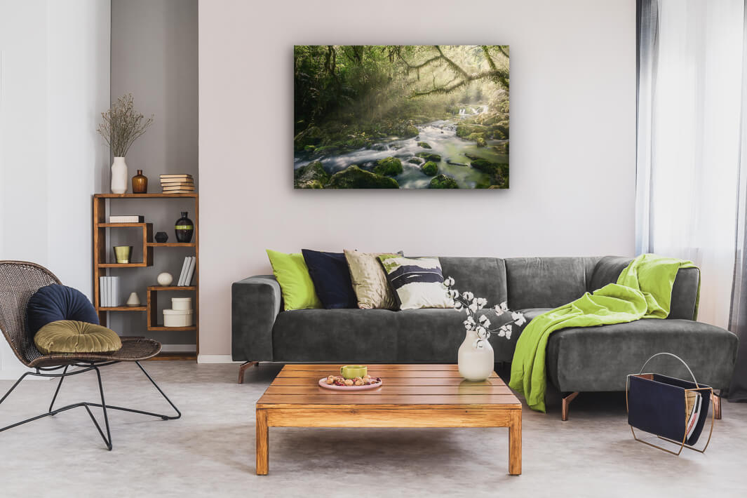 New Zealand landscape photo canvas wall art in neutral lounge setting with a grey couch, coffee tables and books