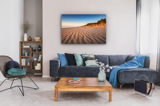 Wall art photo print on modern lounge wall, near a lounge suite, coffee table and bookcase.