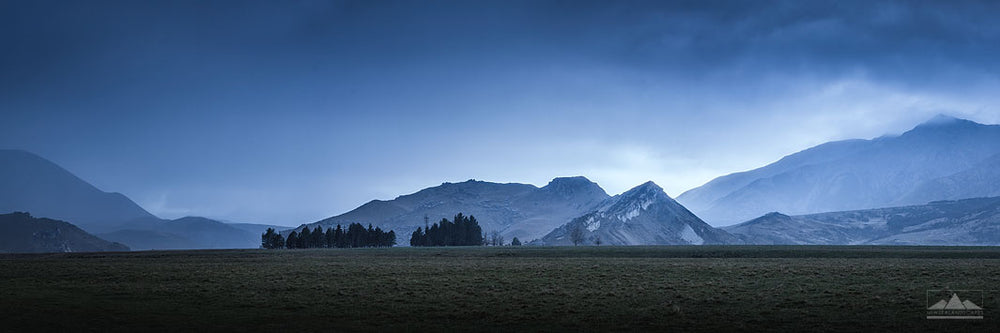Landscape photograph of New Zealand mountains with a blue colour in the sky, taken near Castle Hill