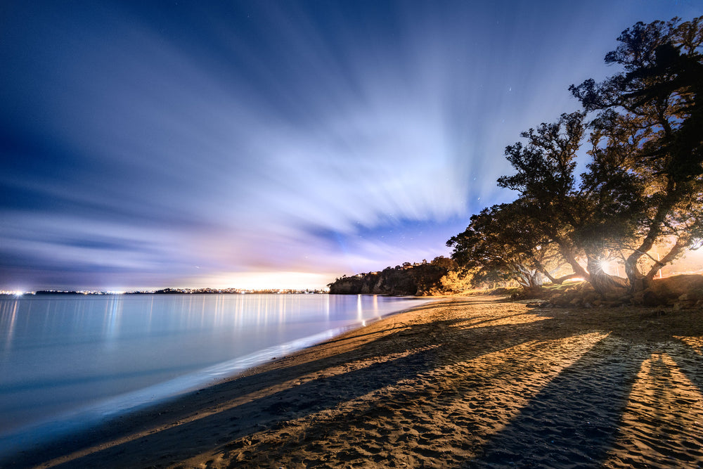 Night photo at Hatfields Beach in Auckland. Smooth water from a long exposure.