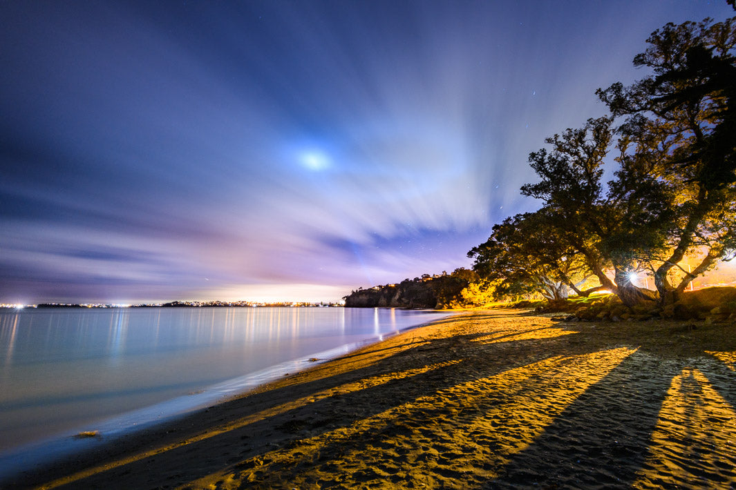 Sunset night photo at Hatfields Beach in Auckland. Smooth water from a long exposure.