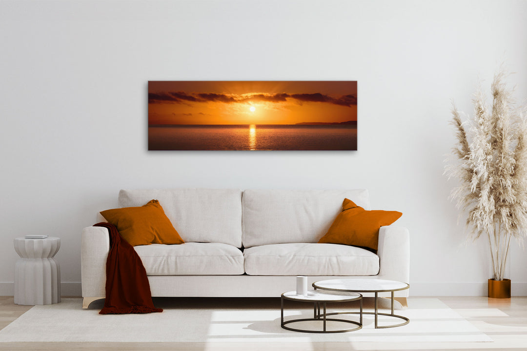 Canvas photo wall art of New Zealand landscape in neutral lounge setting with a white couch, cushions, coffee tables and plant