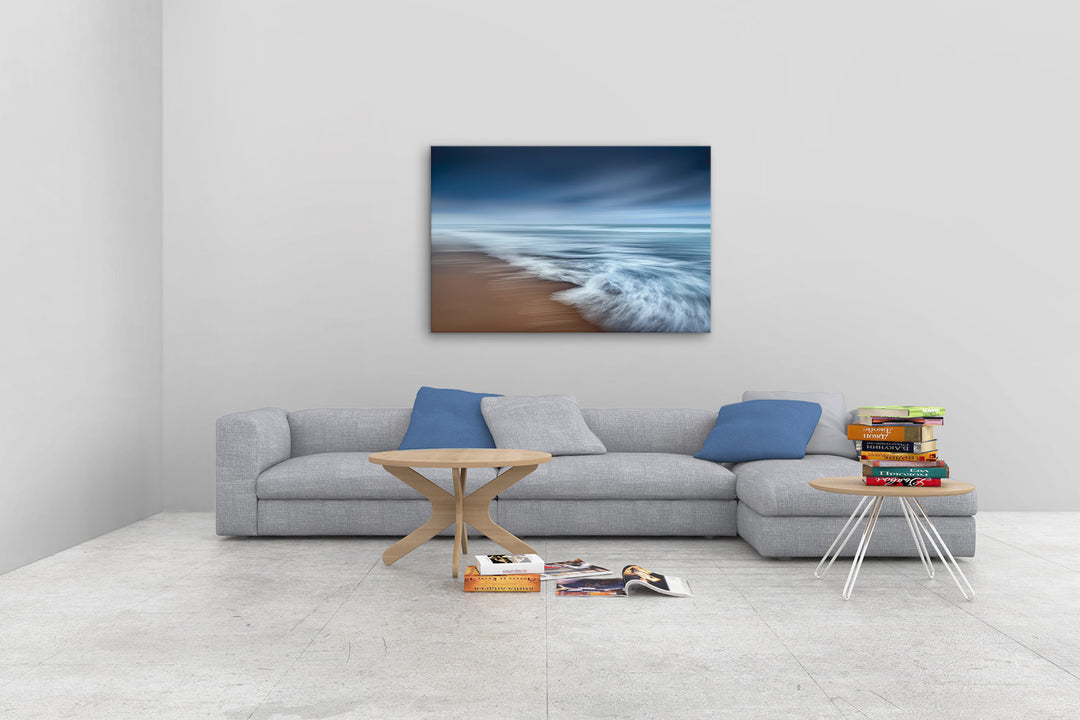 New Zealand landscape photo canvas wall art in neutral lounge setting with a grey couch, coffee tables and books