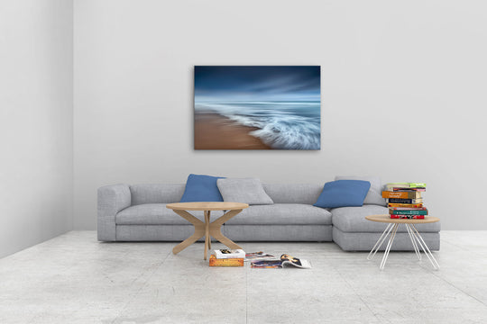 New Zealand landscape photo canvas wall art in neutral lounge setting with a grey couch, coffee tables and books