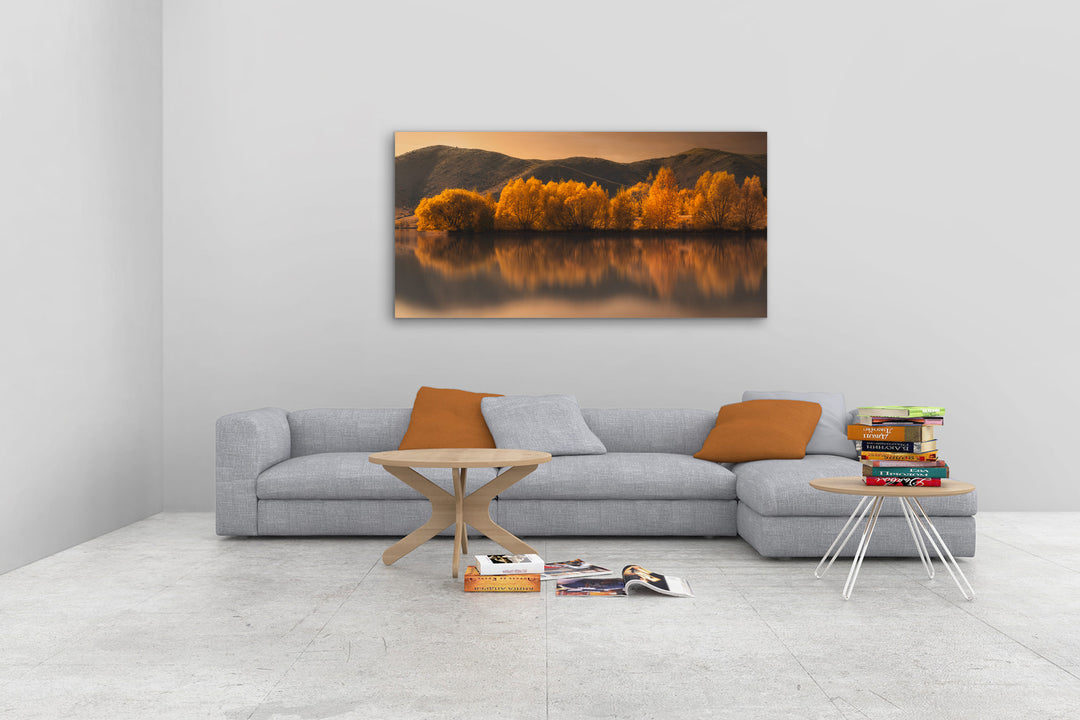 New Zealand landscape photo canvas wall art in neutral lounge setting with a grey couch, coffee tables and books