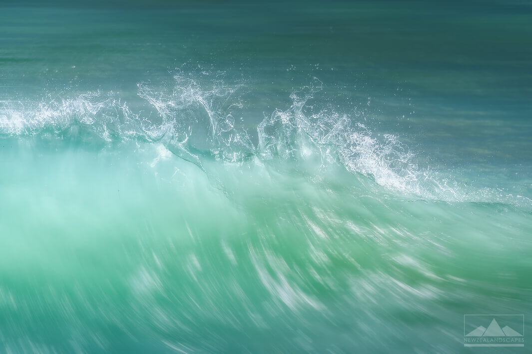 The crest of a New Zealand ocean wave in aqua colour tones