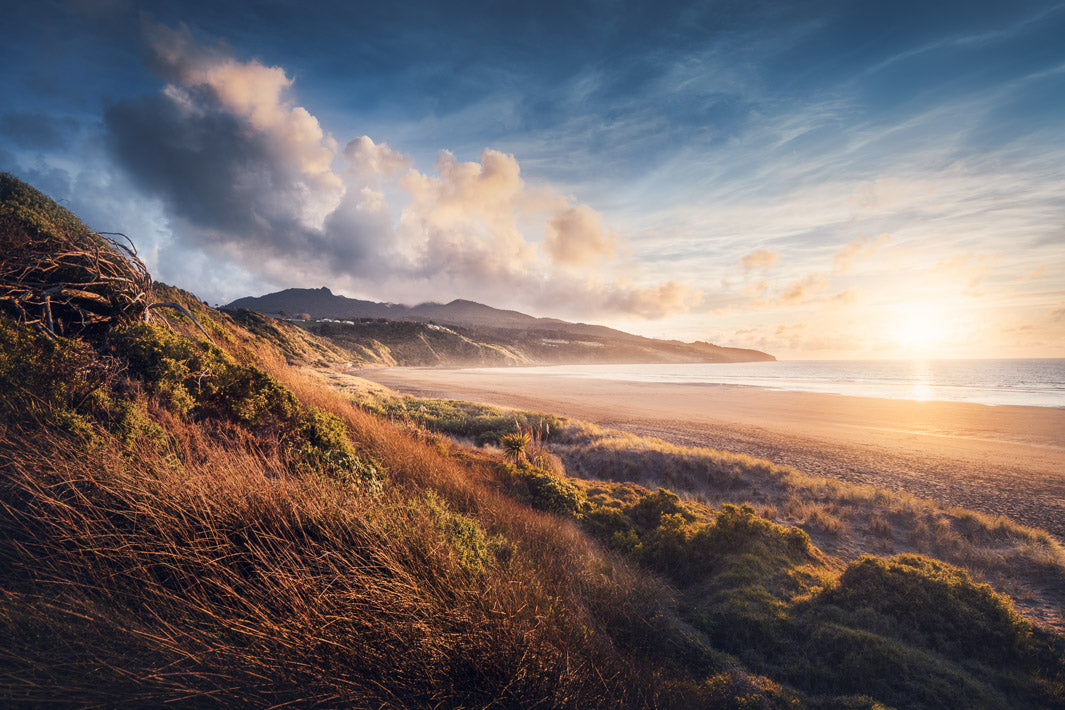 Sunset over the black sand beach of Ngarunui in Raglan, Waikato