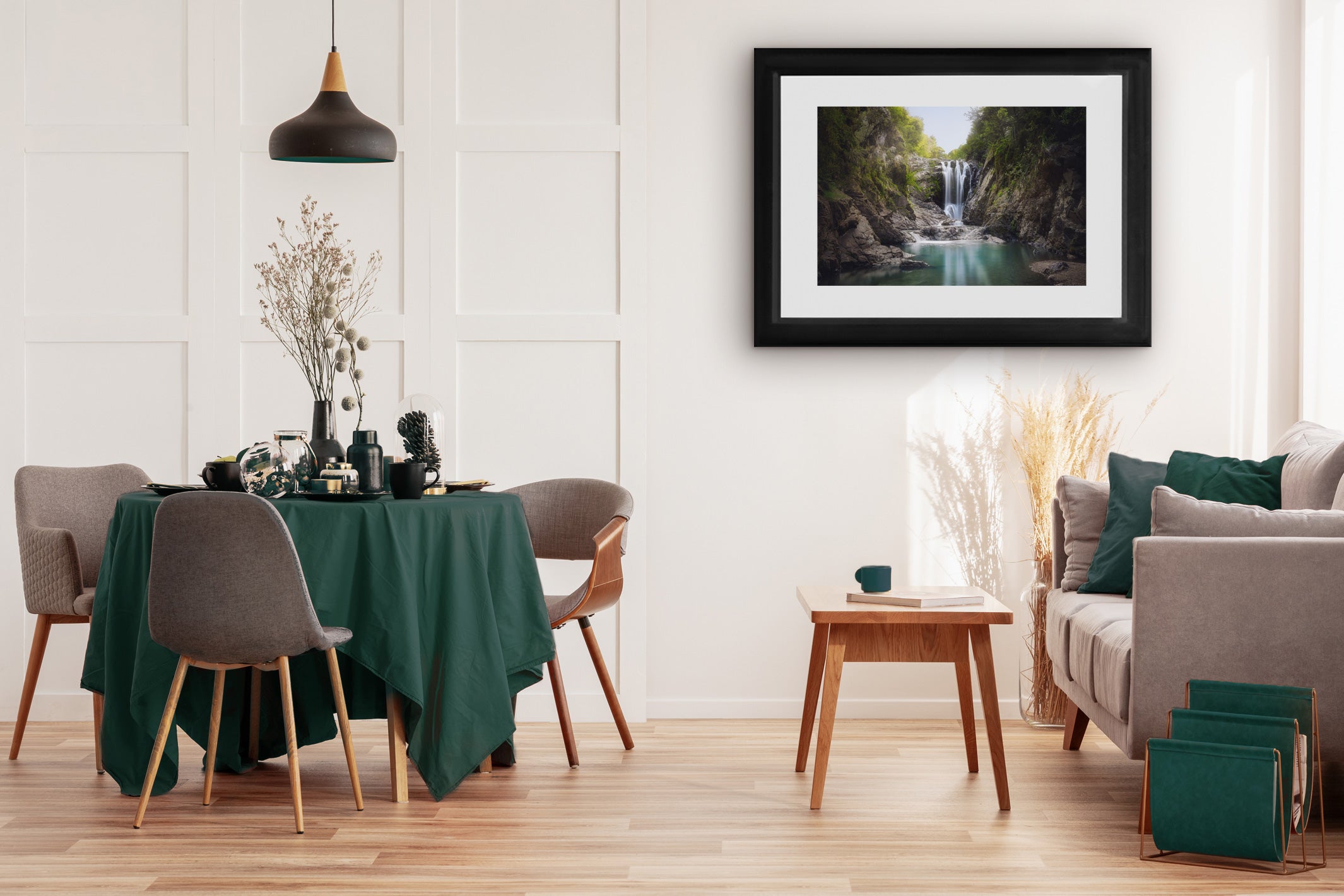 Piroa Falls print on a light wall above a dining table and chairs, showing the waterfall landscape bringing a calming natural element to the space.