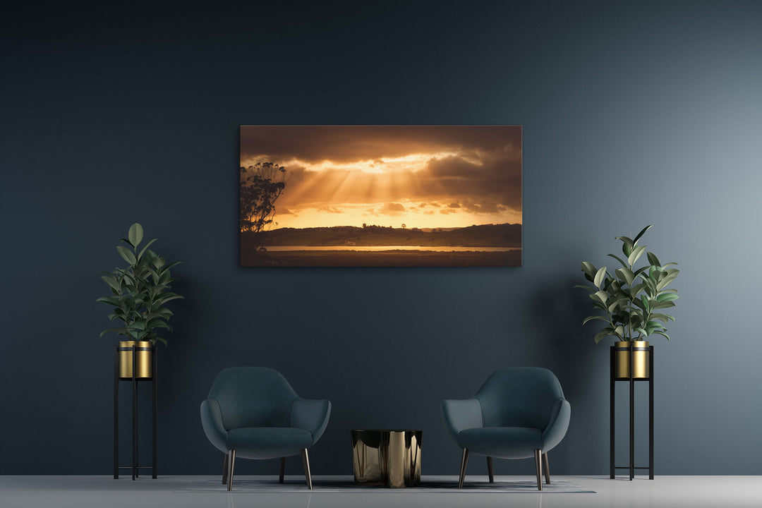 New Zealand landscape canvas photo print on a dark wall with two blue chairs and two pot plants
