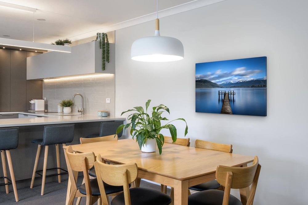 canvas photo print on the wall in a dining room and kitchen with table and chairs in the foregrouond