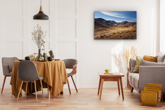 Image contains a photo print on the wall of a modern space with couch, dining table & chairs and coffee table.
