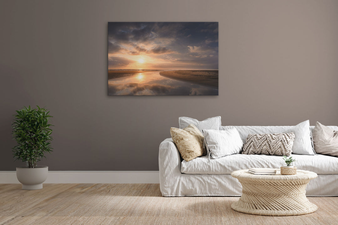 New Zealand landscape canvas photo wall art in lounge setting with a brown wall, white couch, coffee table, plant, cushions