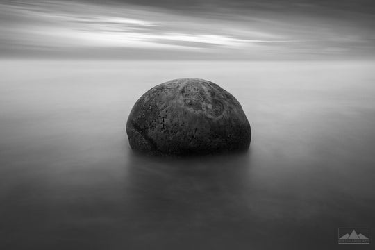 Otago's Moeraki boulder in smooth long exposure black & white photo