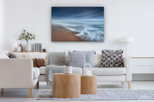 Canvas photo wall art of New Zealand landscape in neutral lounge setting with a white couch, rug, cushions, coffee tables and plant
