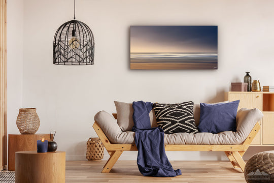 Canvas photo wall art ofNew Zealand landscape canvas print in lounge setting with a couch, cushions, coffee tables, and pendant light.