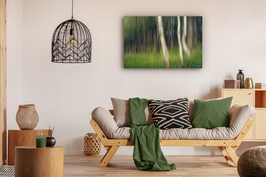 Abstract photo print of trees in a forest displayed on a lounge wall