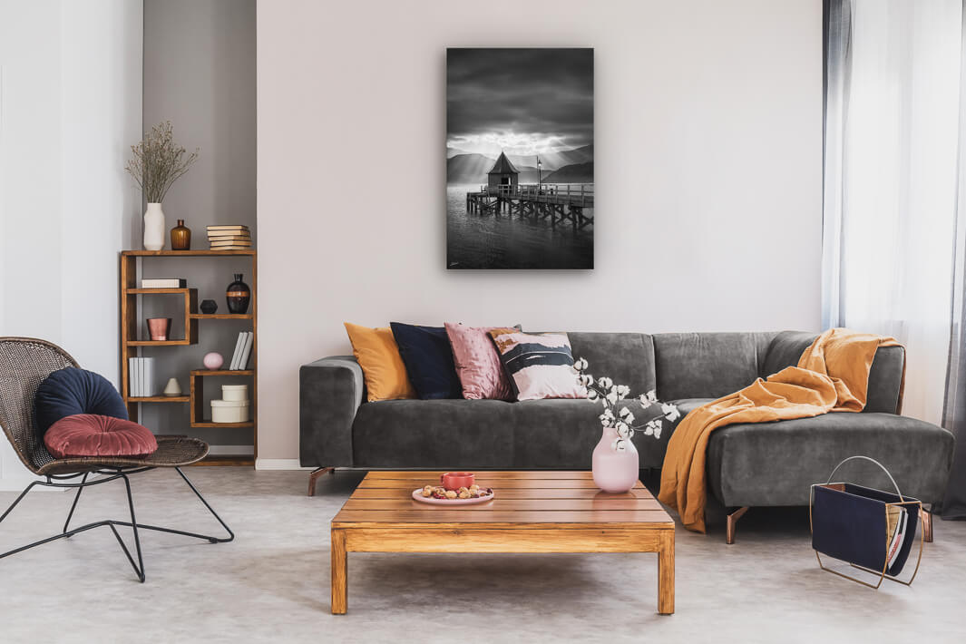 Lounge room with black and white canvas print on the wall of the jetty in Akaroa