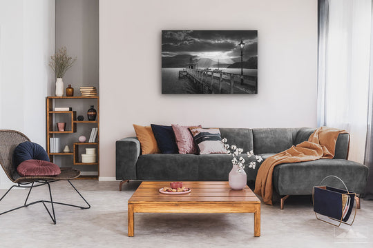 Black and white wall photo print of sunset in Akaroa harbour on display on living room wall