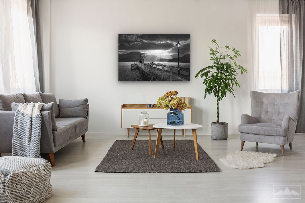 Canvas black and white wall print of sunset in Akaroa harbour on display on lounge wall