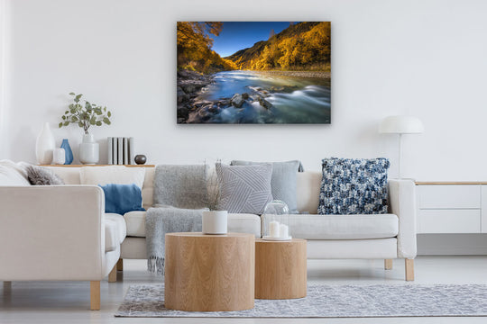 Modern lounge with a canvas print on the wall of Arrowtown at autumn.