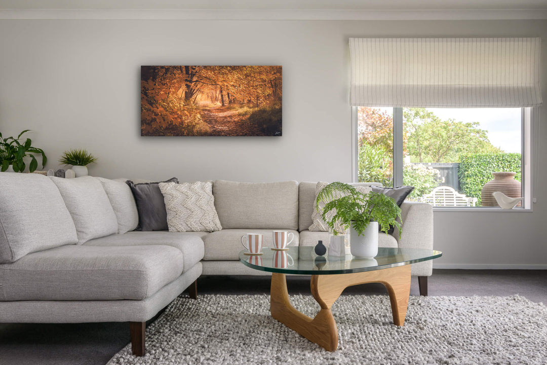 Lounge room with canvas print on the wall of Arrowtown in autumn.
