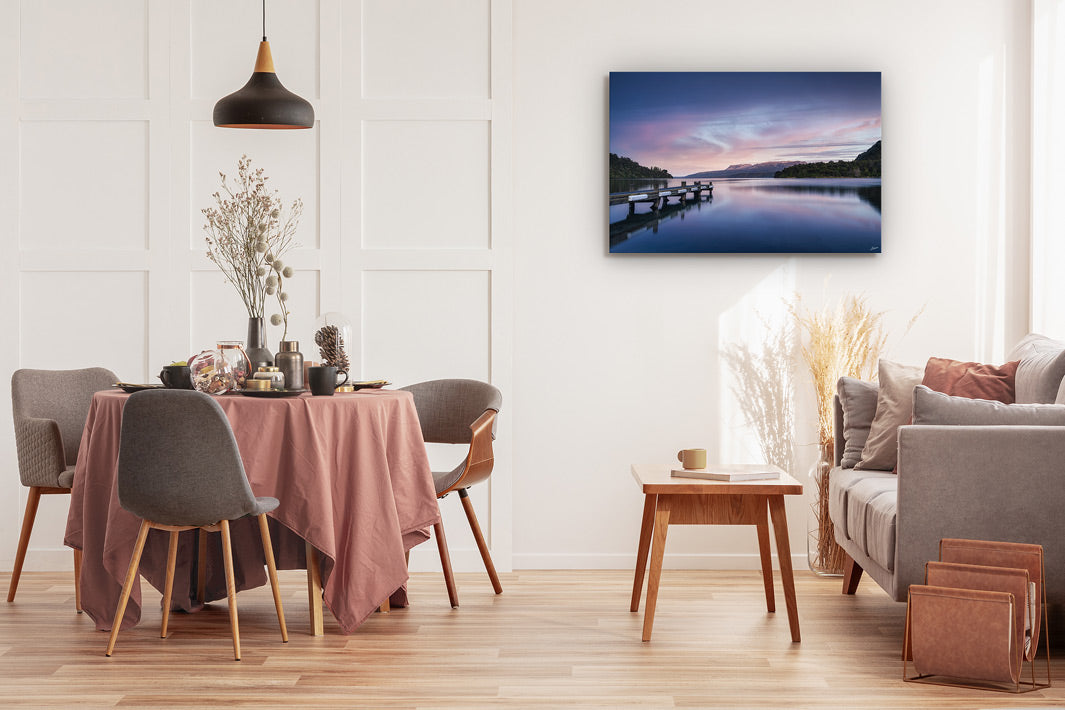 Canvas print on the wall of a lounge setting with table and chairs, couch and coffee table