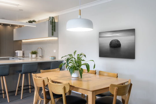 Canvas photo print of a Moeraki boulder displayed on a dining room wall.