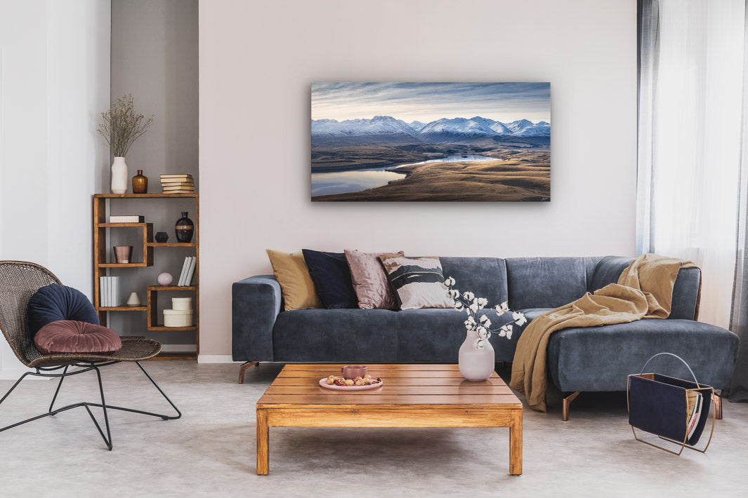 Landscape fine art wall print in a modern lounge with couches, coffee table and occasional furniture.