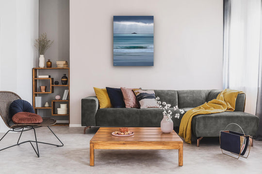 New Zealand landscape photo canvas wall art in neutral lounge setting with a grey couch, coffee tables and books