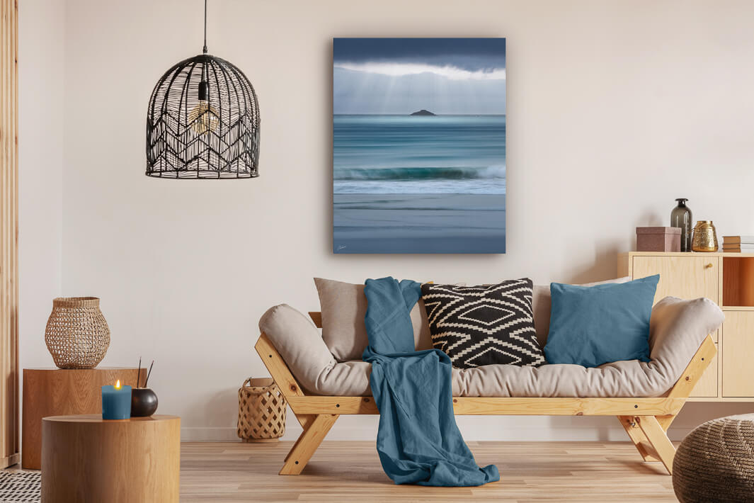 Canvas photo wall art of New Zealand landscape canvas print in lounge setting with a couch, cushions, coffee tables, and pendant light.