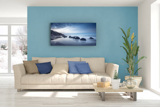 Lounge suite with soft furnishings and plants, with a large photographic canvas wall print.