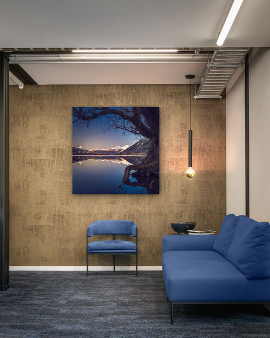 Canvas photo of New Zealand landscape on the wall of an office with couch and chair