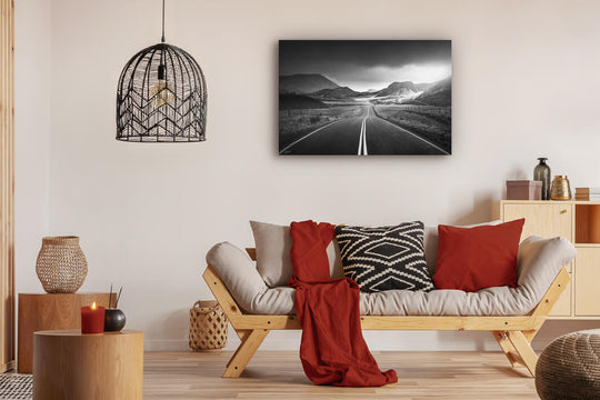 Canvas photo wall art of New Zealand landscape canvas print in lounge setting with a couch, cushions, coffee tables, and pendant light.