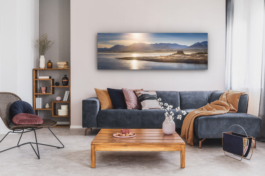 Panoramic photo print or canvas displayed on a lounge wall above a couch and coffee table. 